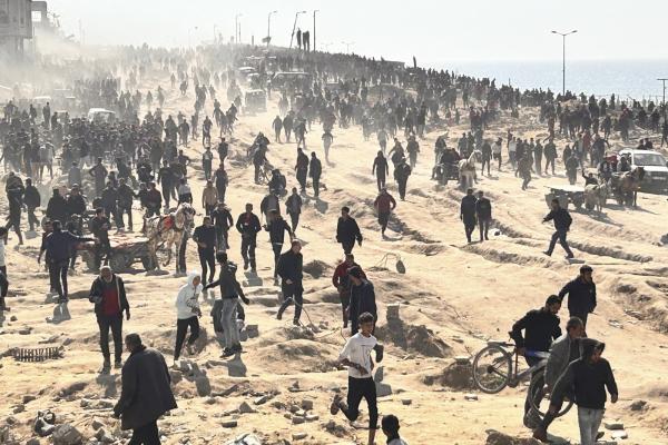 Palestinians wait for humanitarian aid on a beachfront in Gaza City, Gaza Strip, February 25, 2024.