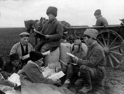 Peasants on a collective farm in the Soviet Union, 1930 read during a break. In a campaign to banish illiteracy among peasants the Soviet government sent millions of books, newspapers and magazines to villages across the country.