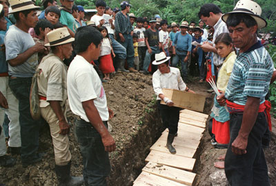 Mayan men bury victims of a 1982 massacre in a mass grave in Chel, a remote village in northern Guatemala on July 4, 1998.