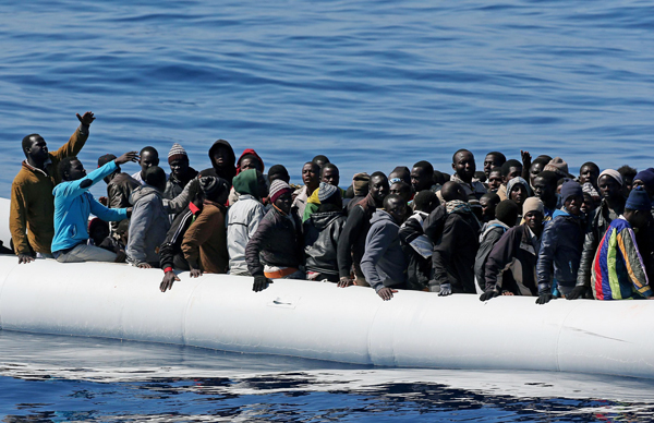 African migrants on an overcrowded inflatable dinghy who were intercepted off the coast of Libya by the Italian coast guard in April.