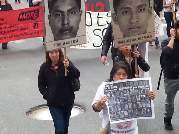 Volunteers with Revolution/revcom.us display the Stolen Lives poster