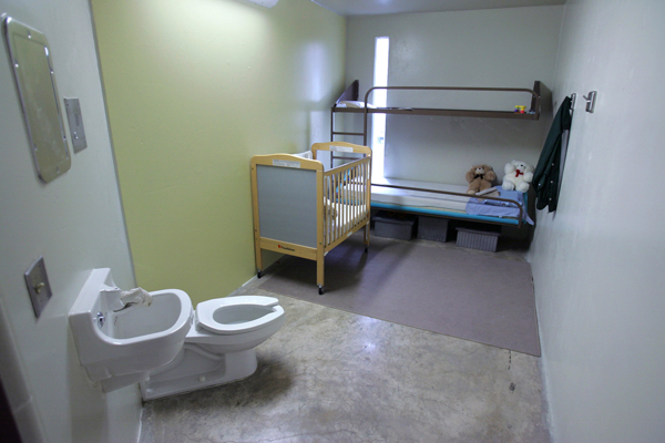 A cell with a crib and children's toys that houses an immigrant family at a detention center in Taylor, Texas.