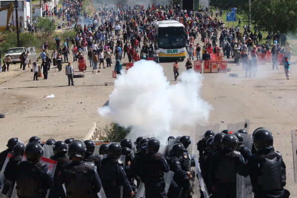 Protesting teachers face off against riot police on a federal highway  near the town of Nochixtlan, Mexico, June 19.