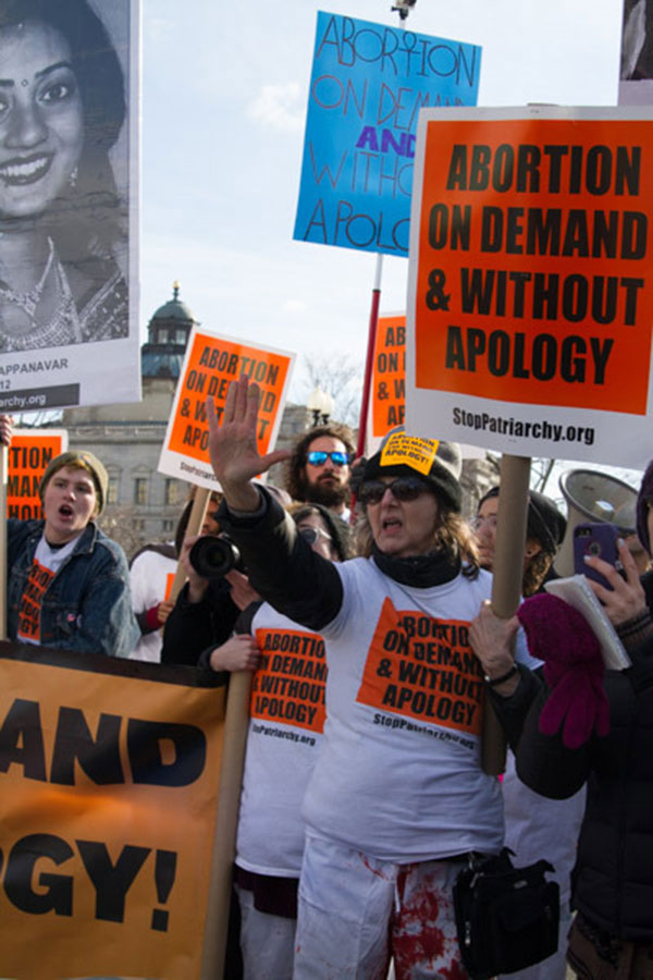 Women protestors hold up signs 'Abortion on demand and without apology.'