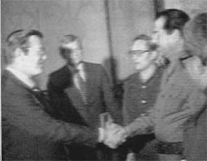 Donald Rumsfeld shaking hands with Saddam Hussein.