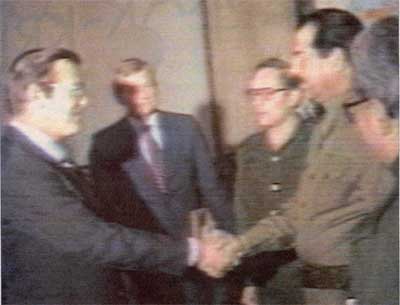 Saddam and Rumsfeld shaking hands in 1983