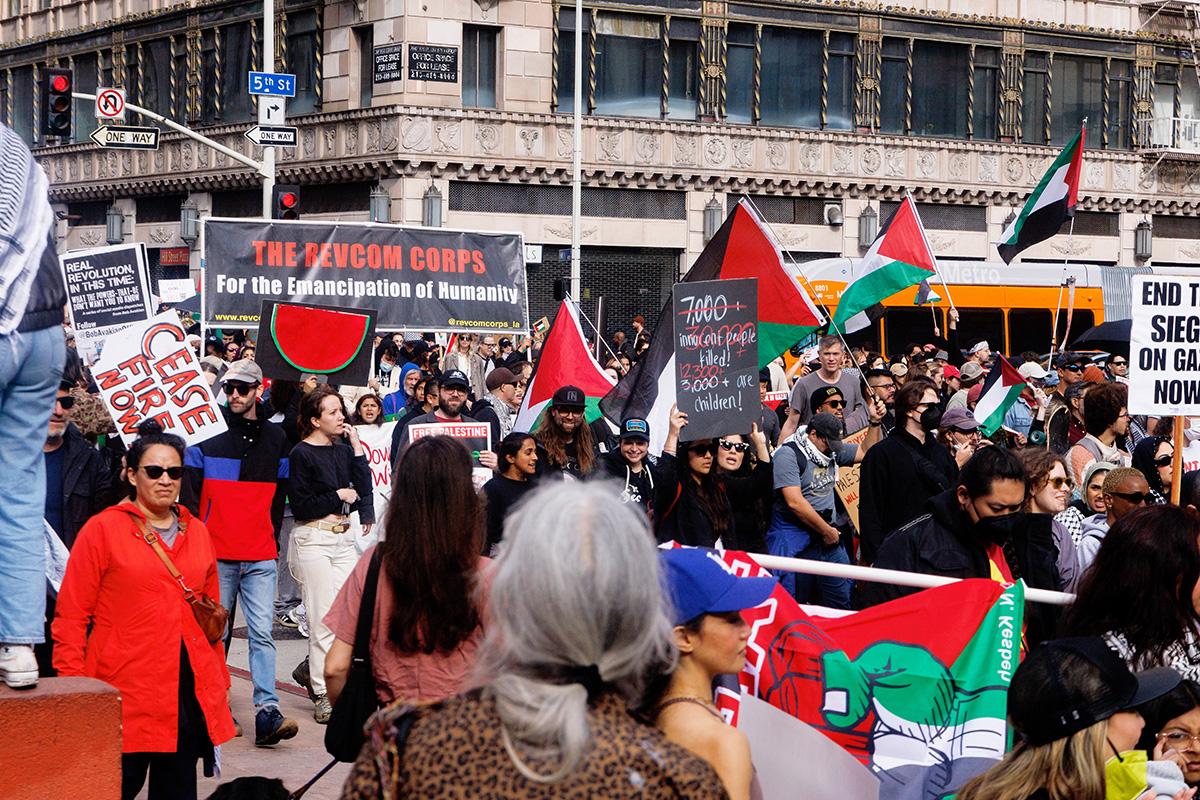 Los Angeles, March 2, 2024: The Revcom Corps banner in the midst of thousands who came into the streets on a rainy day to protest genocide in Palestine.