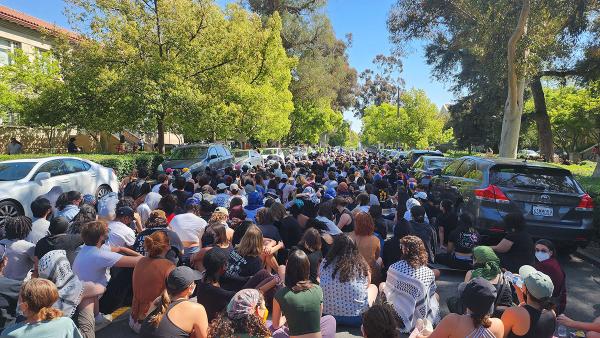 Hundreds of Students walk out and sit in street at Pomona College, April 11, 2024.