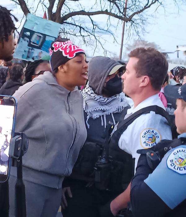Sister of Dexter Reed, murdered by Chicago cops, confronts cops at protest.