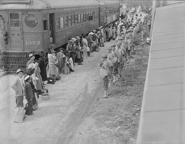 People of Japnese descent lined up at a train that will take them to the concentration camp at Gila River, Ariz., 1942. 