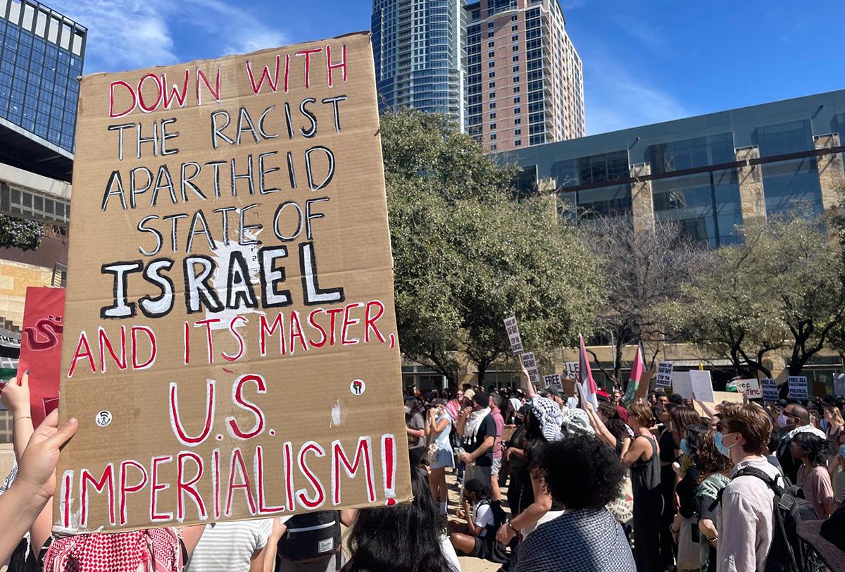 Austin, TX, March 2, 2024: Hands Off Rafah rally with sign identifying U.S. imperialism and where revcoms bring revolutionary message.