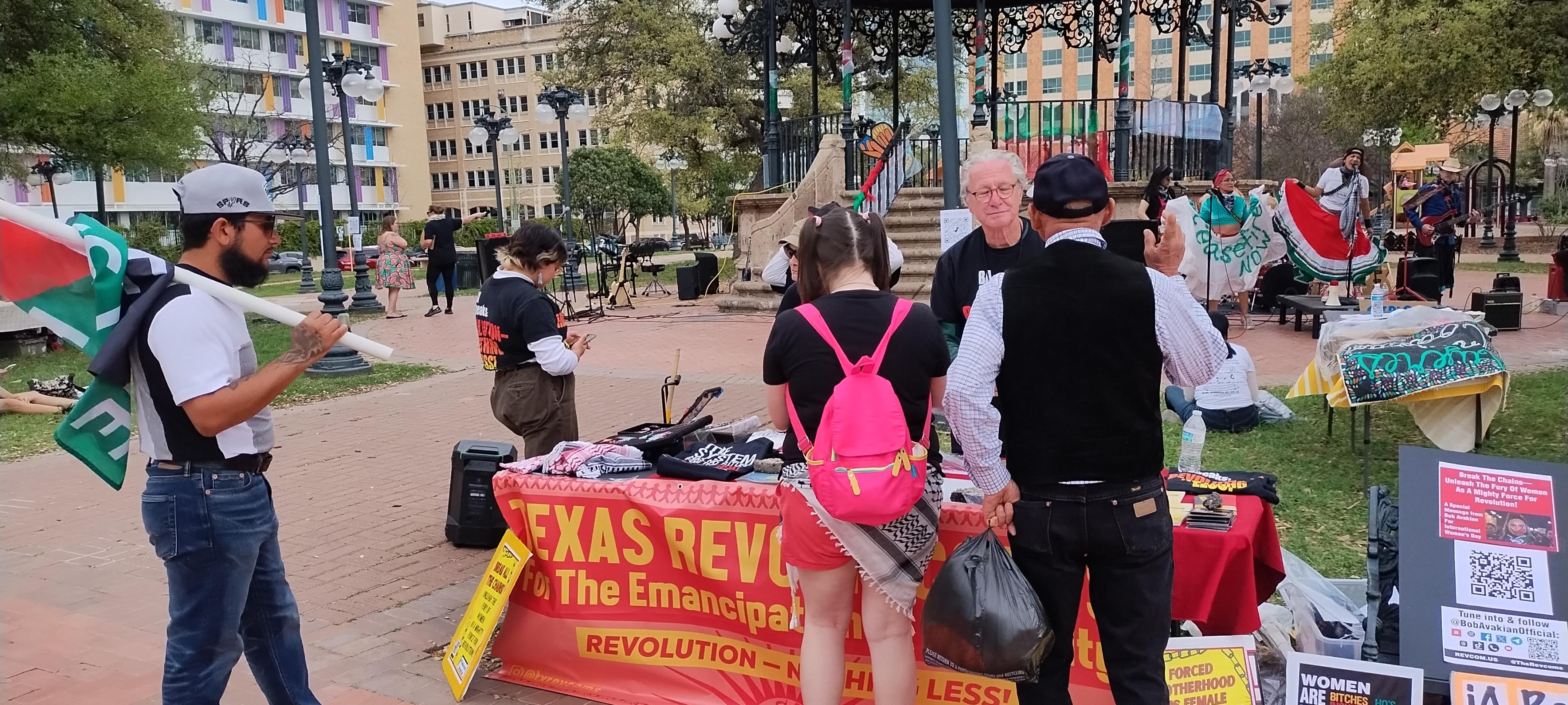 Table at park in San Antonio with banner: Texas Revcom Corps for The Emancipation of Humanity