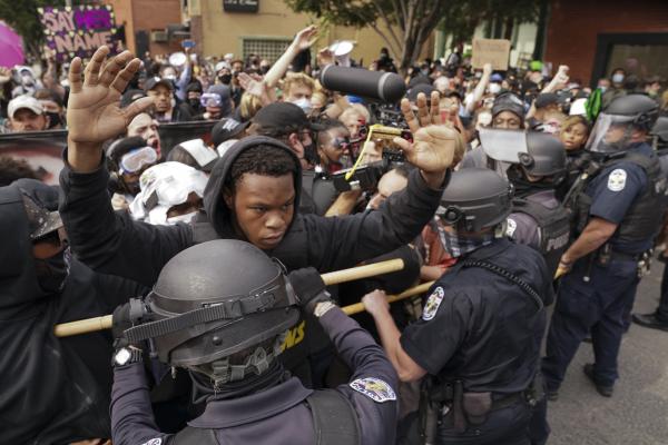 Black young man at head of protest for Breonna Taylor is confronted by police in Louisville, Kentucky.