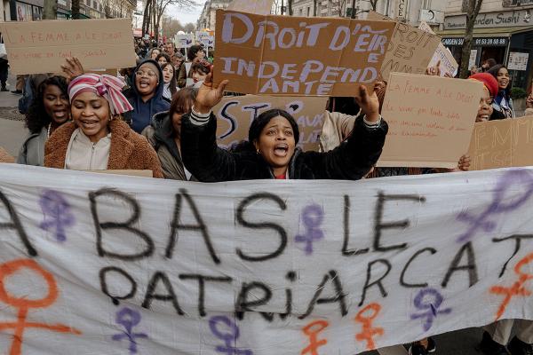 IWD Paris, France women with banner against patriarchy