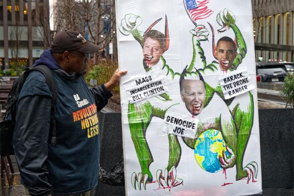 New York City, Radio City protest: poster of Genocide Joe, Barack the Drone Ranger, and Mass Incarceration Bill Clinton, March 28, 2024.